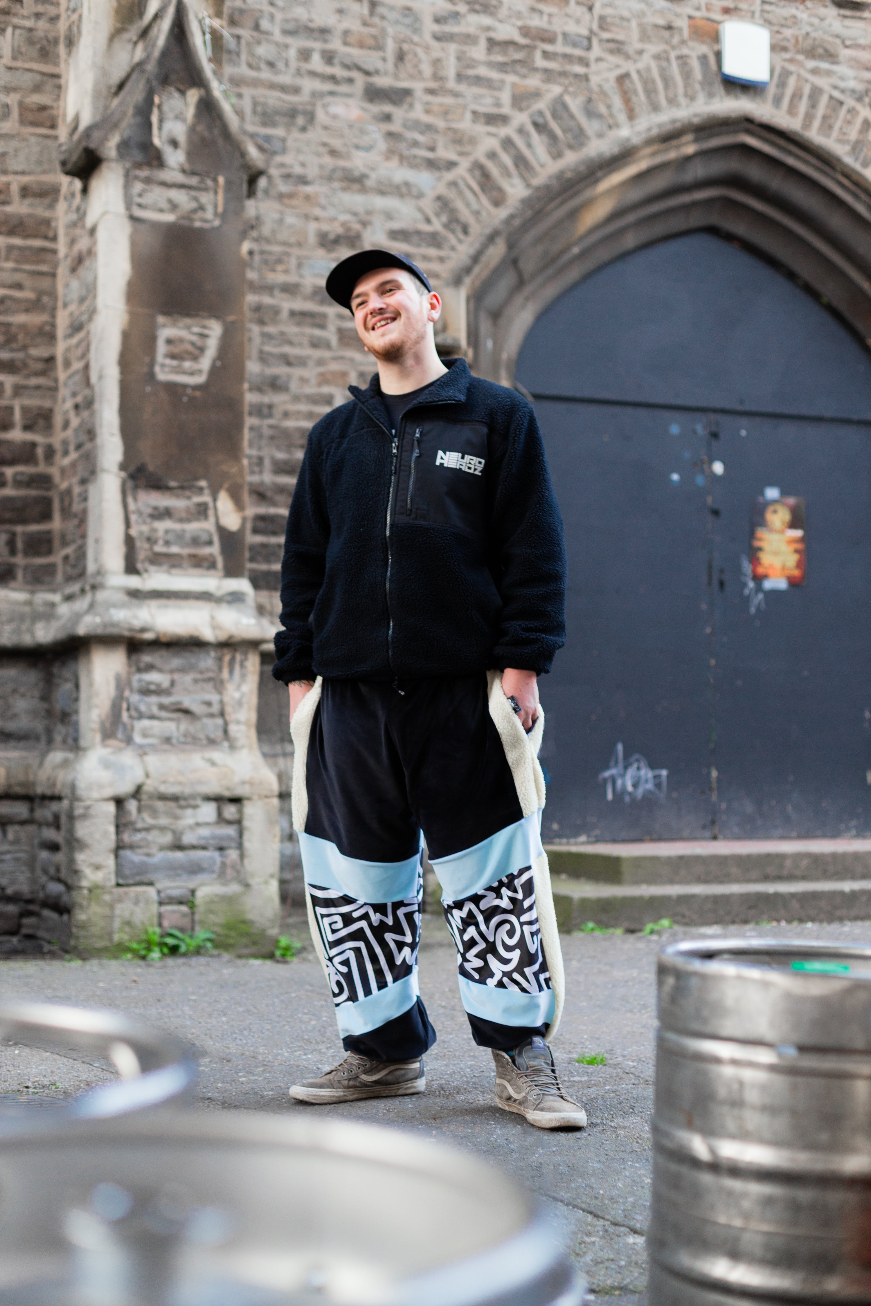 drum and bass label owner wears blue black and white panelled velour funky mens tracksuit bottoms